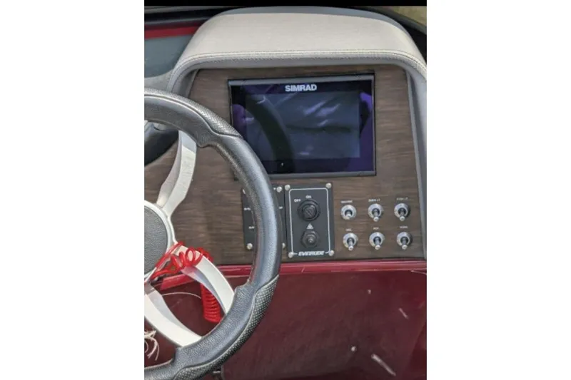Slide: The Image of Steering wheel and control panel of 2019 Manitou Legacy 25 RFXW boat. - 30
