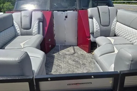 Slide: The Image of 2019 Manitou Legacy 25 RFXW boat dashboard with steering wheel and Simrad display. - 7