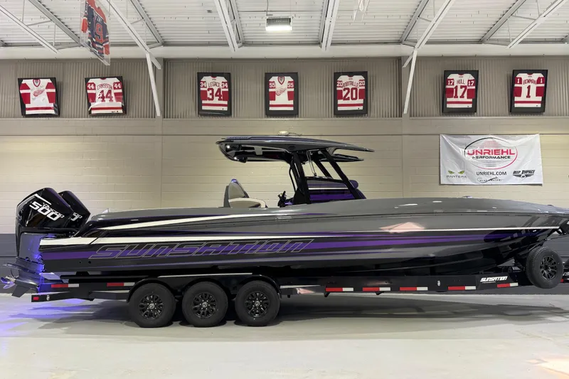 The Image of 2026 Sunsation 32 CCX boat in showroom, sleek design with purple accents. - 0