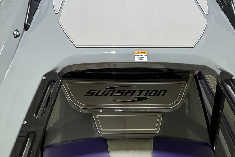 Slide: The Image of 2026 Sunsation 32 CCX boat interior with logo and service warning sign. - 16
