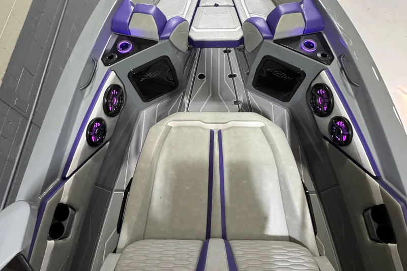 Slide: The Image of 2026 Sunsation 32 CCX boat interior with purple accents and modern seating design. - 17
