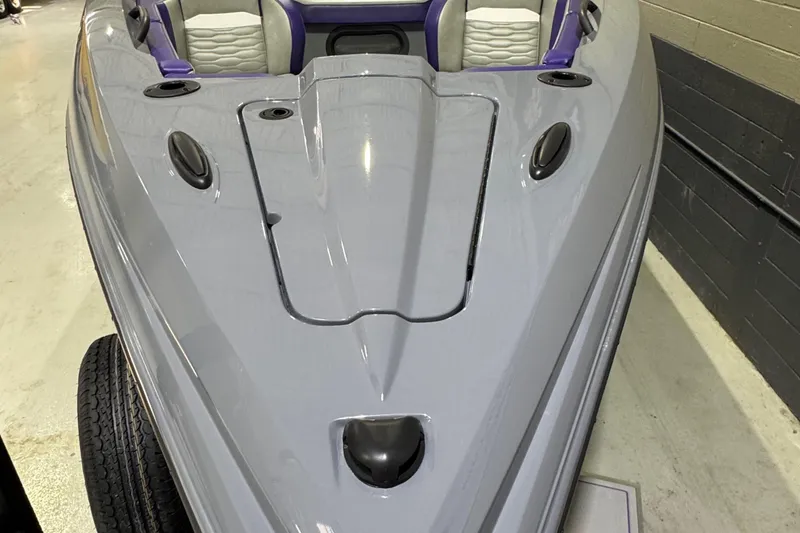 Slide: The Image of 2026 Sunsation 32 CCX boat, sleek design, gray exterior, purple and white seating. - 20