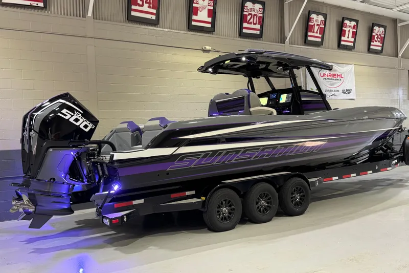 Slide: The Image of 2026 Sunsation 32 CCX boat with powerful engines on a trailer in a showroom. - 3