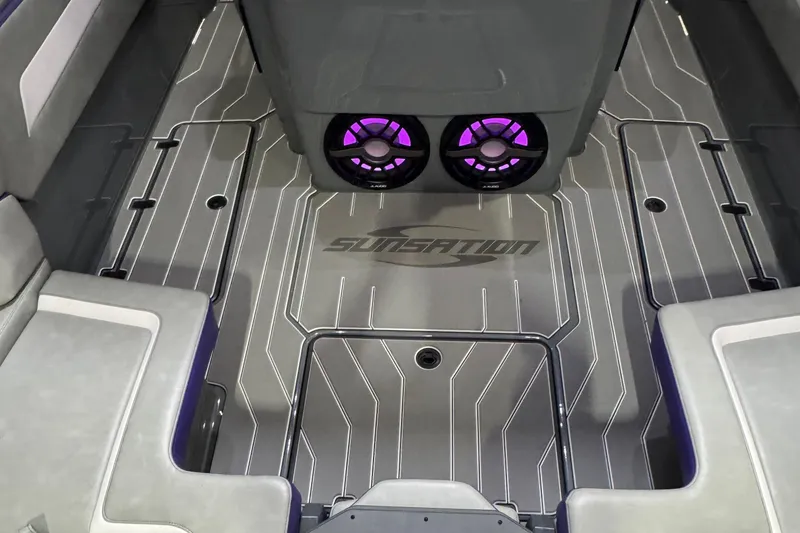 Slide: The Image of 2026 Sunsation 32 CCX boat interior with stylish flooring and illuminated speakers. - 9