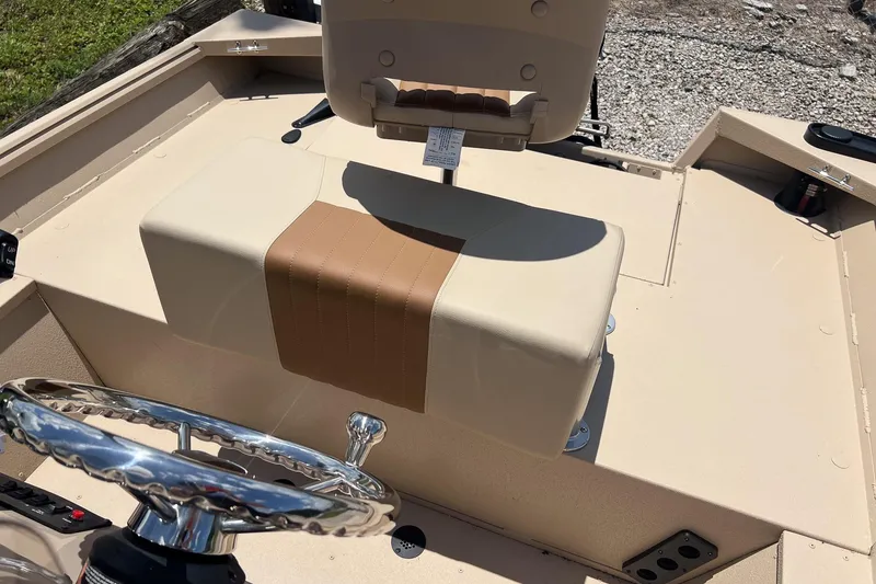 Slide: The Image of 2025 G3 Bay 17 boat interior with beige seating and chrome steering wheel. - 10