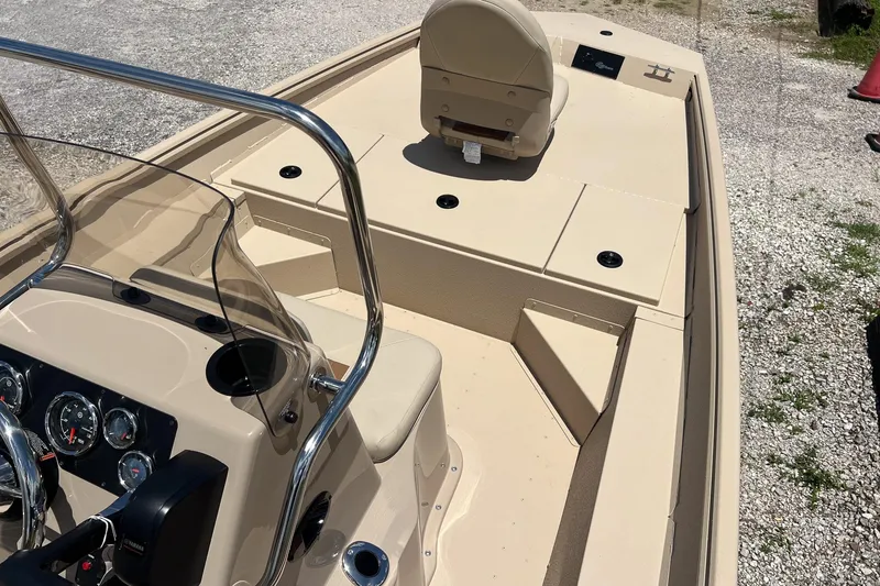 Slide: The Image of 2025 G3 Bay 17 boat interior with beige seating and console, parked on gravel. - 6