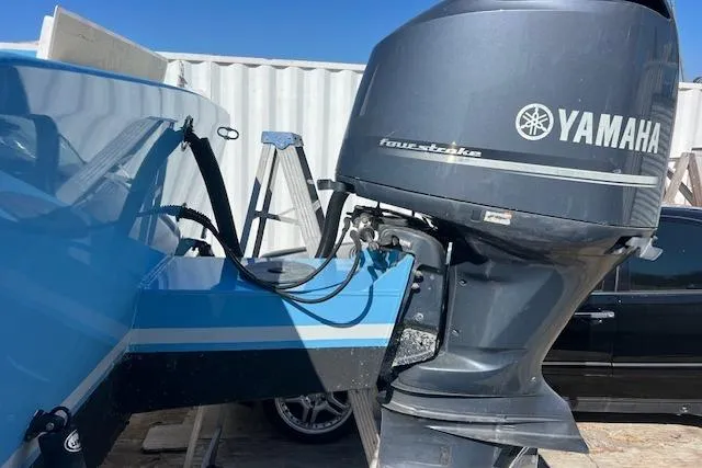 Slide: The Image of 1971 Mariners BAJA 30 boat with Yamaha four-stroke outboard motor, parked outdoors. - 10