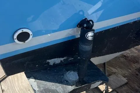 Slide: The Image of 1971 Mariners BAJA 30 boat detail showing trim tab and hull in blue and black. - 11