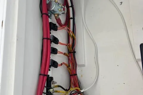 Slide: The Image of Electrical wiring inside a 1971 Mariners BAJA 30 boat, featuring organized cables and connectors. - 17