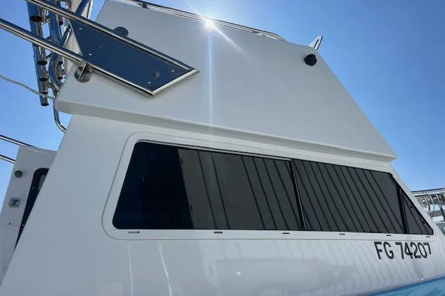 Slide: The Image of 1971 Mariners BAJA 30 boat exterior with sleek design and large windows under bright sunlight. - 5