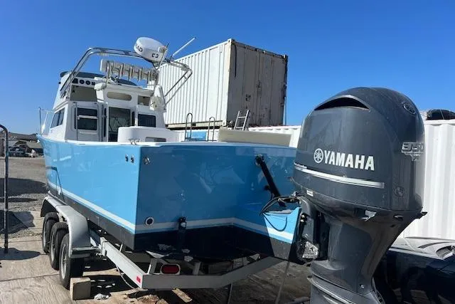 Slide: The Image of 1971 Mariners BAJA 30 boat with Yamaha engine on trailer, blue hull, outdoor setting. - 7