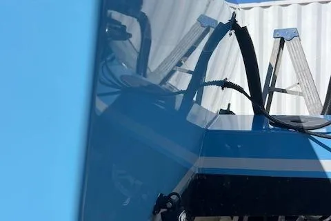 Slide: The Image of 1971 Mariners BAJA 30 boat with blue and black exterior, reflecting nearby objects. - 9