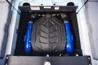 Slide: The Image of 2025 MasterCraft XT22 T engine with blue accents in boat compartment. - 11
