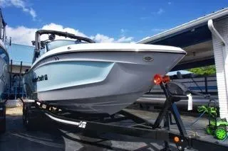 Slide: The Image of 2025 MasterCraft XT22 T boat on trailer, parked outdoors under blue sky. - 3