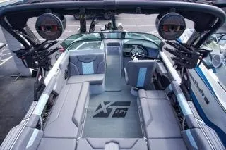 Slide: The Image of 2025 MasterCraft XT22 T boat interior with sleek seating and advanced audio system. - 5