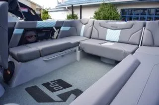 Slide: The Image of 2025 MasterCraft XT22 T boat interior with gray seating and modern design. - 7