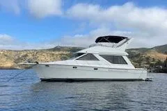 Slide: The Image of 2001 Bayliner 3988 Motoryacht on calm water with scenic background. - 1