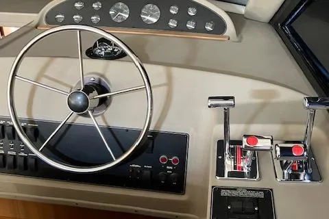 Slide: The Image of 2001 Bayliner 3988 Motoryacht helm with steering wheel and control panel. - 12