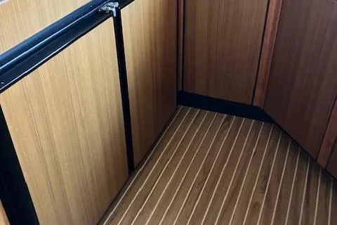 Slide: The Image of 2001 Bayliner 3988 Motoryacht interior with wood paneling and striped flooring. - 14