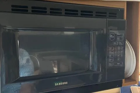 Slide: The Image of Samsung microwave in a 2001 Bayliner 3988 Motoryacht kitchen. - 18