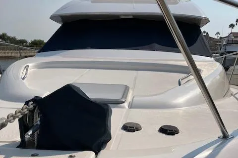 Slide: The Image of 2001 Bayliner 3988 Motoryacht, sleek design, docked with covered windows. - 2