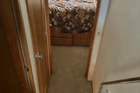 Slide: The Image of Interior view of 2001 Bayliner 3988 Motoryacht bedroom with floral bedding. - 26