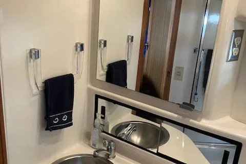 Slide: The Image of 2001 Bayliner 3988 Motoryacht bathroom with sink, mirror, and towel holder. - 31