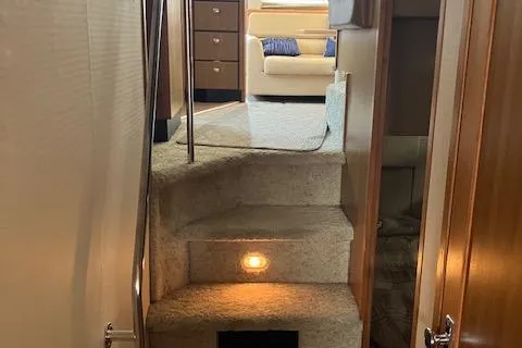 Slide: The Image of Interior view of 2001 Bayliner 3988 Motoryacht, featuring carpeted stairs and cozy living area. - 34