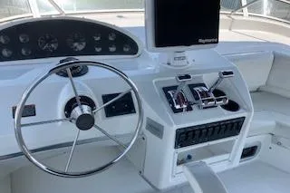 Slide: The Image of 2001 Bayliner 3988 Motoryacht helm with steering wheel and control panel. - 41