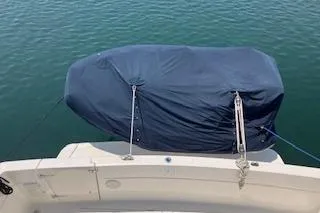 Slide: The Image of 2001 Bayliner 3988 Motoryacht with covered equipment on deck, docked on calm water. - 49