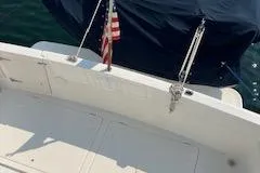 Slide: The Image of 2001 Bayliner 3988 Motoryacht deck with American flag, docked on calm water. - 52