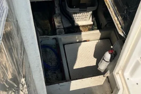 Slide: The Image of 2001 Bayliner 3988 Motoryacht engine room with fire extinguisher and storage basket. - 58