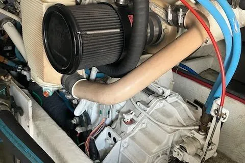 Slide: The Image of Engine compartment of a 2001 Bayliner 3988 Motoryacht, showcasing mechanical components and hoses. - 61