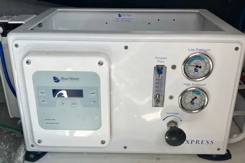 Slide: The Image of Blue Water Express control panel on 2001 Bayliner 3988 Motoryacht, featuring pressure gauges and flow meter. - 66