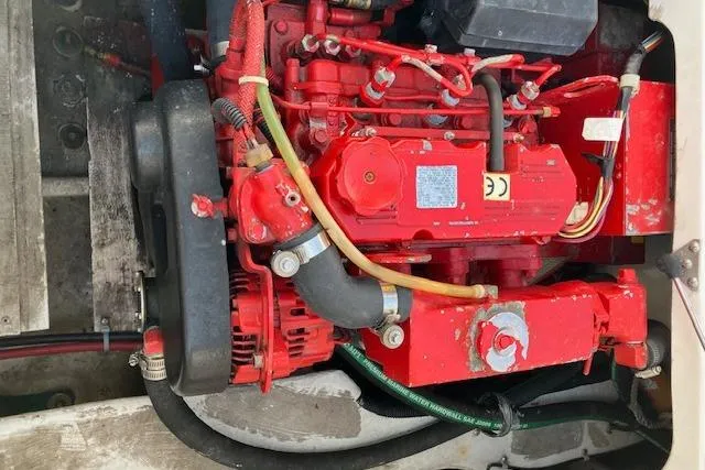 Slide: The Image of Engine of 2001 Bayliner 3988 Motoryacht, featuring red components and visible hoses. - 69
