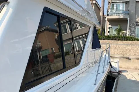 Slide: The Image of 2001 Bayliner 3988 Motoryacht docked near residential buildings. - 7