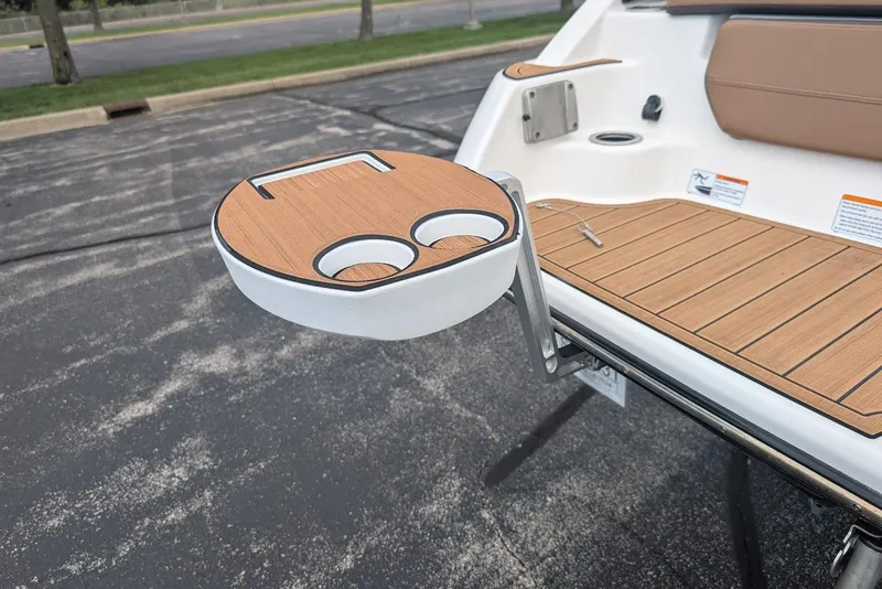 Slide: The Image of 2024 Yamaha Boats 252SE with teak-style swim platform and cup holder. - 12