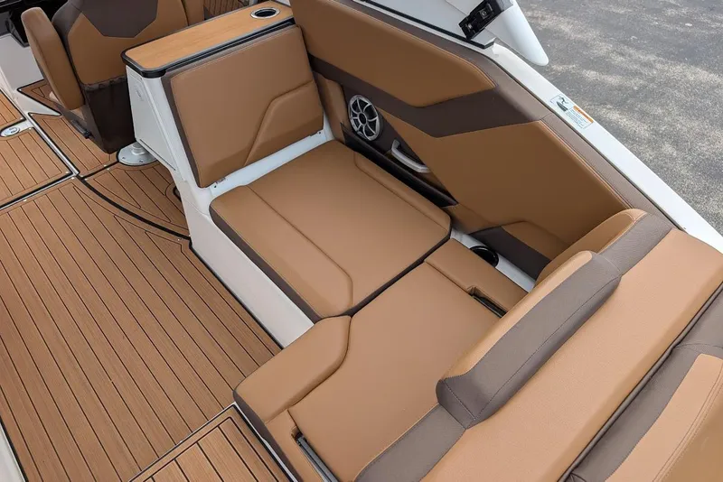 Slide: The Image of 2024 Yamaha Boats 252SE interior with tan seating and wood-style flooring. - 19