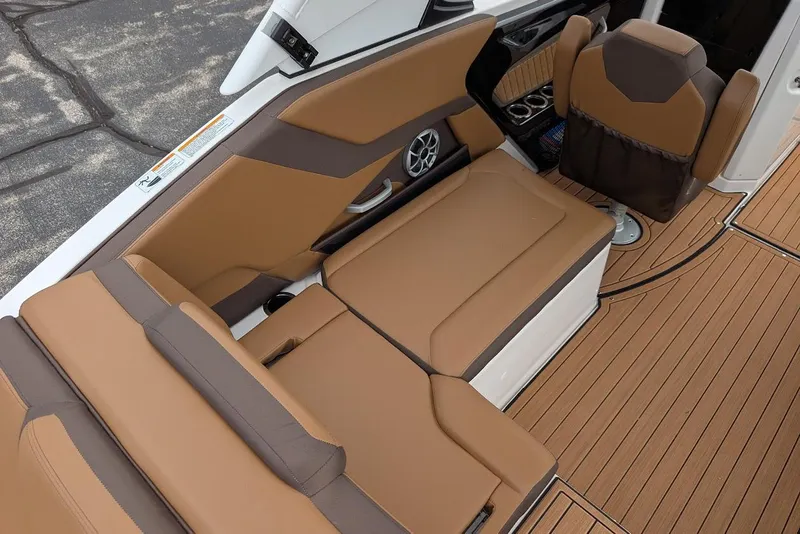Slide: The Image of 2024 Yamaha Boats 252SE interior with tan seating and wood-style flooring. - 20