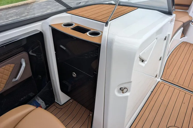 Slide: The Image of 2024 Yamaha Boats 252SE interior with wood accents and storage compartments. - 26