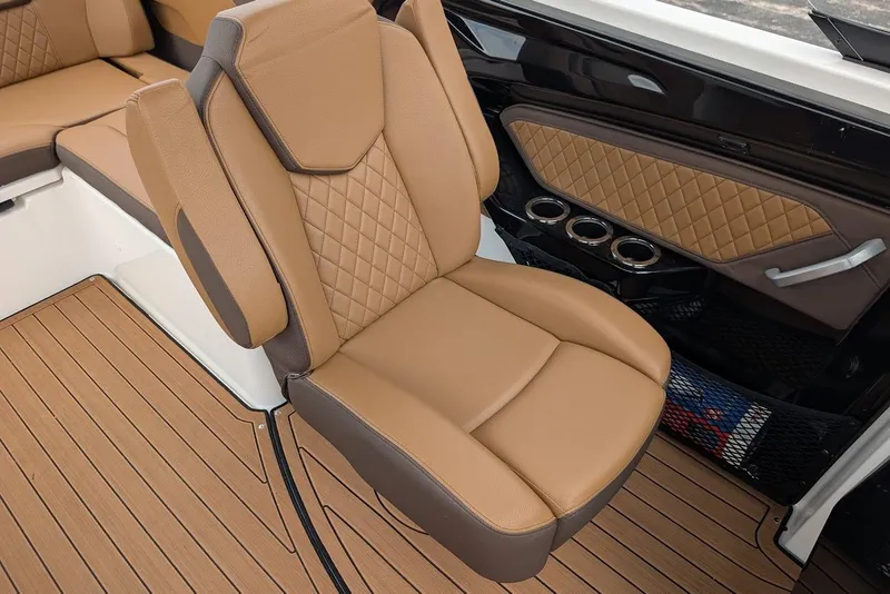 Slide: The Image of 2024 Yamaha Boats 252SE interior with tan leather seating and wood-style flooring. - 27