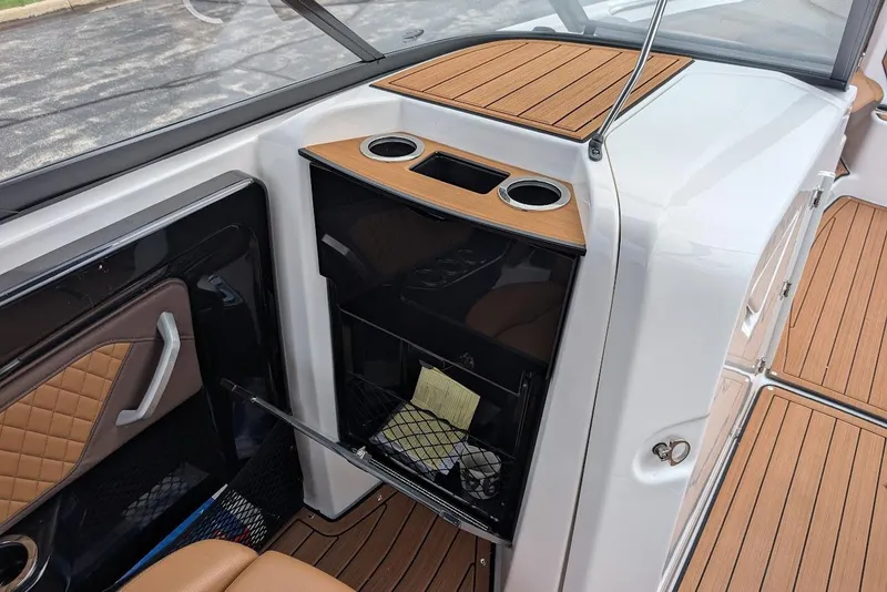 Slide: The Image of 2024 Yamaha Boats 252SE interior with wood accents and storage compartment. - 29