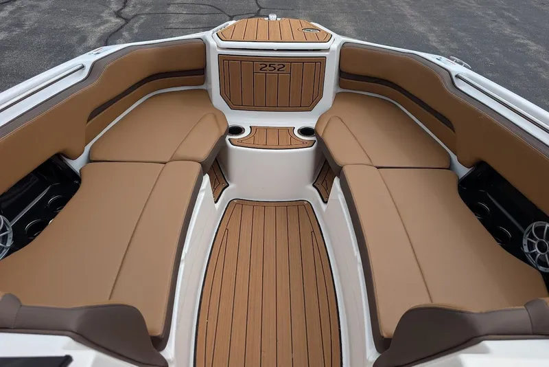 Slide: The Image of 2024 Yamaha Boats 252SE interior with tan seating and wood-style flooring. - 31