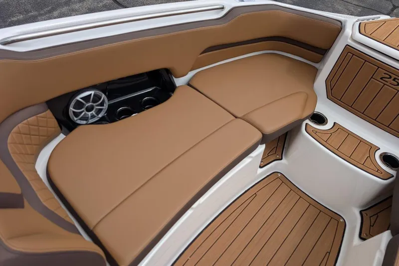 Slide: The Image of 2024 Yamaha Boats 252SE interior with tan seating and wood accents. - 34