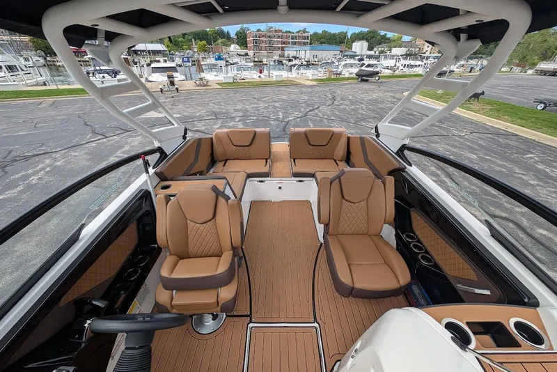 Slide: The Image of 2024 Yamaha Boats 252SE interior with luxurious seating and modern design at a marina. - 37