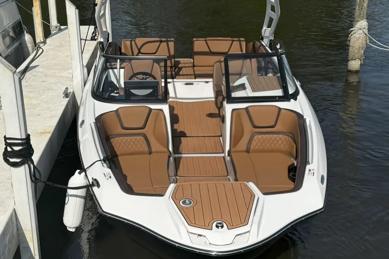 Slide: The Image of 2024 Yamaha Boats 252SE docked, featuring sleek design and luxurious seating. - 4