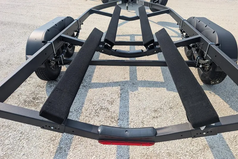 Slide: The Image of 2024 Yamaha Boats 252SE trailer frame on gravel surface. - 43