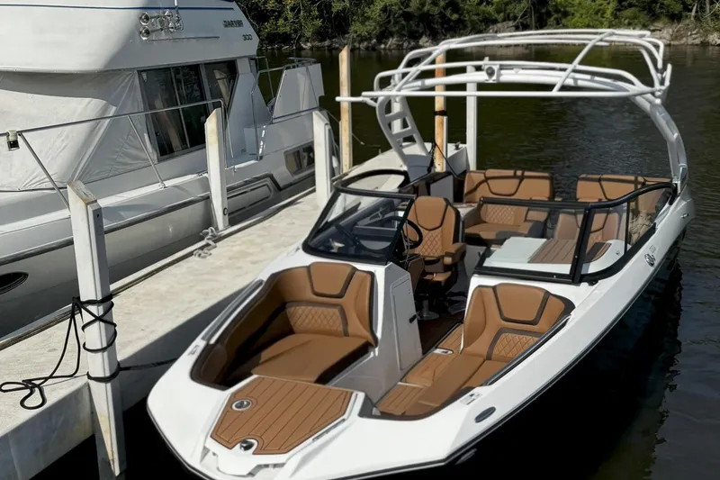 Slide: The Image of 2024 Yamaha Boats 252SE docked, featuring sleek design and luxurious seating. - 5