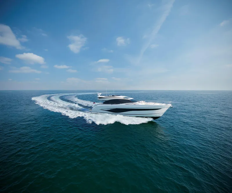 The Image of 2025 Princess S72 yacht cruising on open sea under clear blue sky. - 1