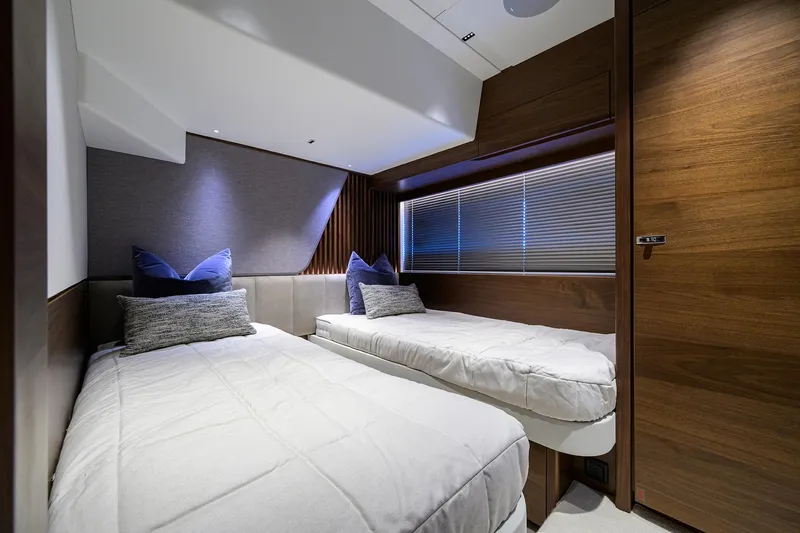 Slide: The Image of Luxurious twin cabin interior of 2026 Princess S72 yacht, featuring modern design and cozy bedding. - 23